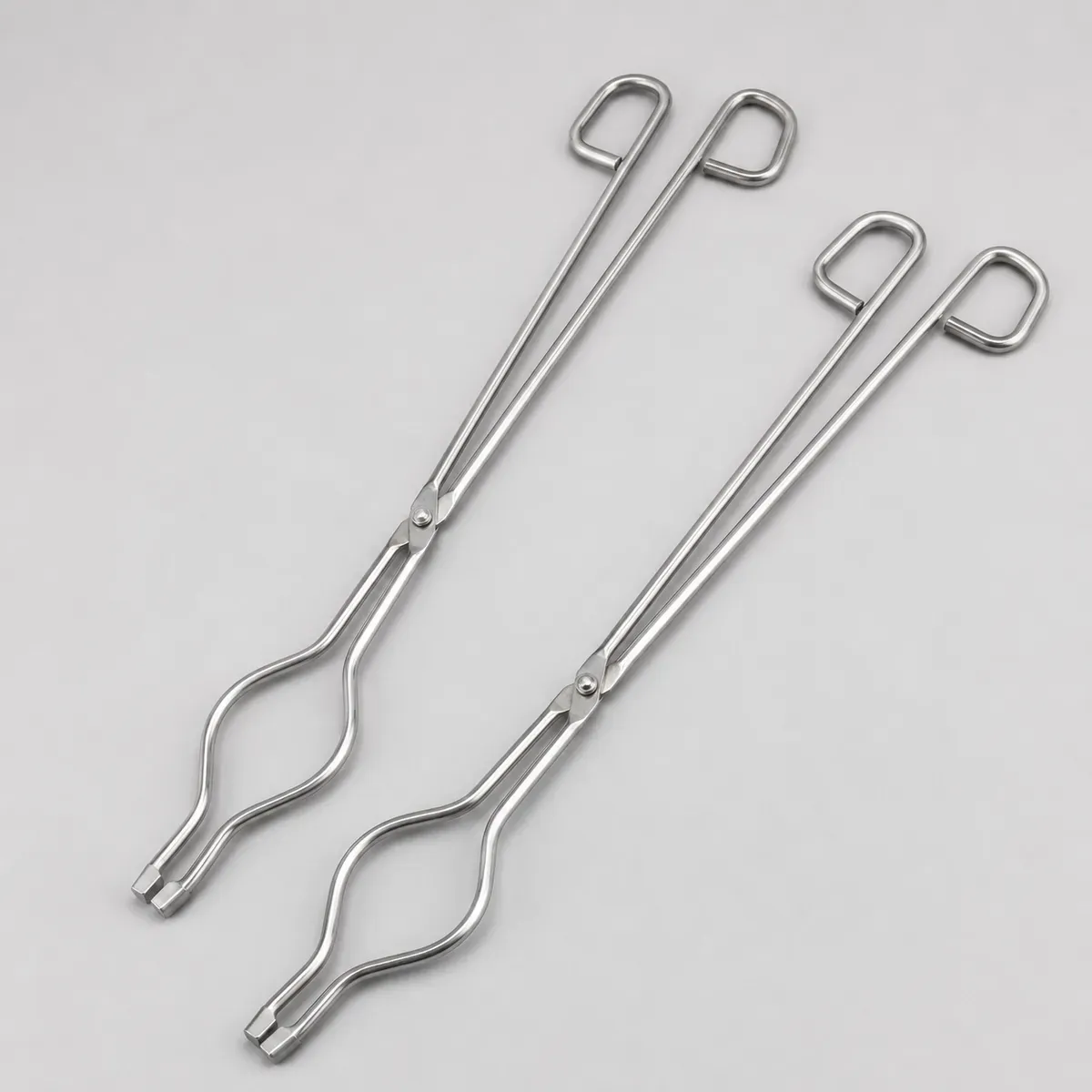 16 inch stainless steel crucible tongs set on clean grey background