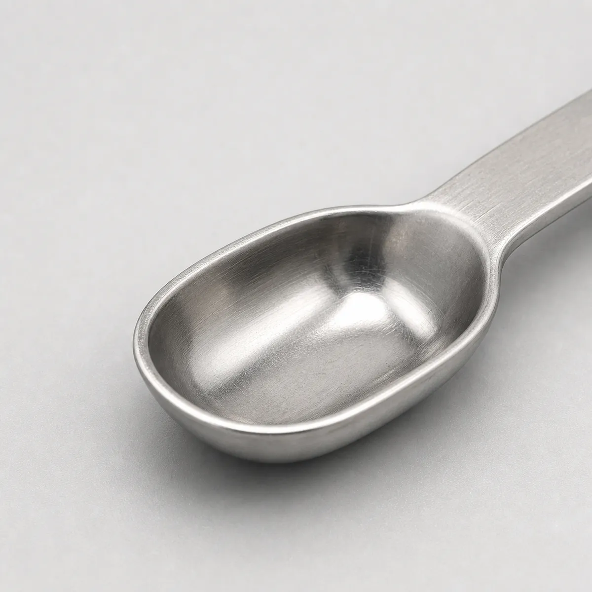 Close-up of polished stainless steel sample spoon bowl for laboratory use