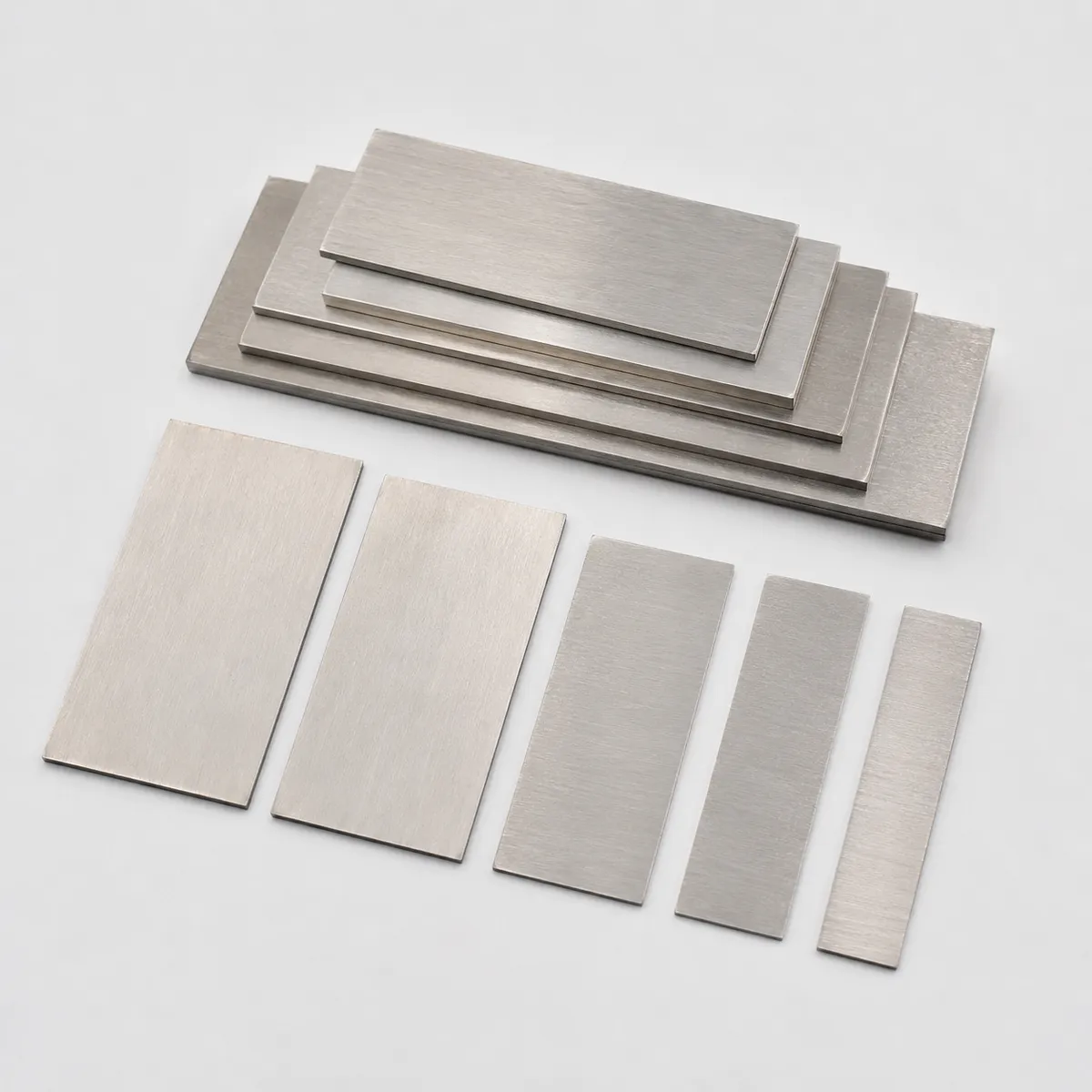 Stainless steel shim set with assorted flat plates on a clean background